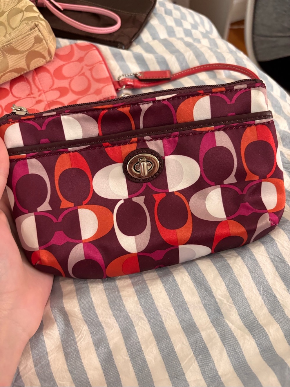 Coach Multi-Color Signature Turnlock Wristlet in Burgundy, Pink & Orange